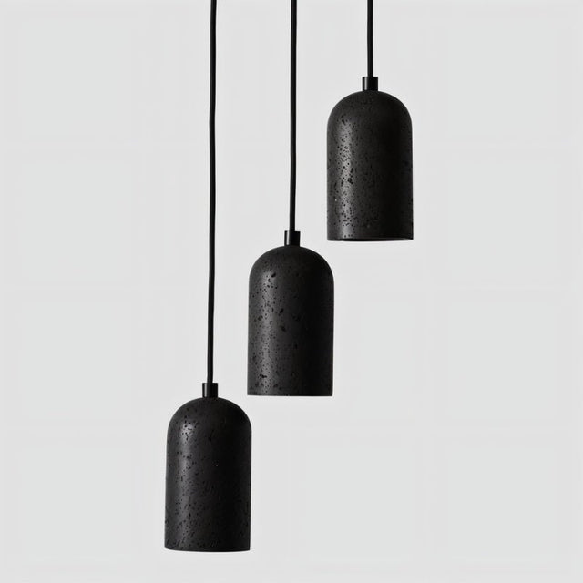"Group of modern cylindrical pendant lights crafted from black travertine, showcasing their natural, textured surface and contemporary design."