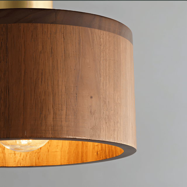 Detailed view of Vesil Copper & Wood Pendant Light Fixture's wood grain and brass top, showcasing craftsmanship.