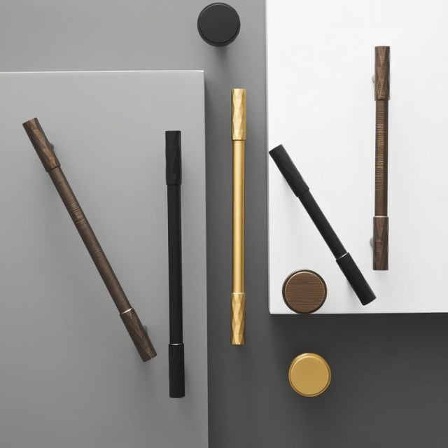 "Modern faceted brass knobs and pull bars in various finishes with a diamond-cut texture on cabinet doors, blending geometric precision with modern luxury."