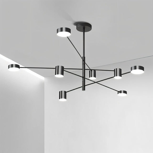"A black chandelier with multiple arms extending in different directions, each with a small, round light at the end, shown installed on a white ceiling."