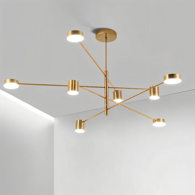 "A gold chandelier with multiple arms extending in different directions, each with a small, round light at the end, shown installed on a white ceiling."