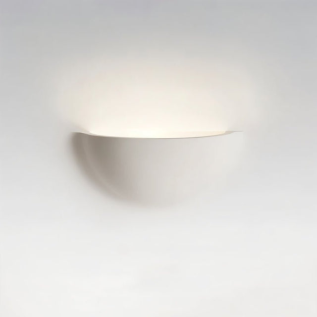 "Sleek, minimalist, half-moon shaped trimless light made of gypsum and metal, seamlessly integrated into a white wall, providing a soft, ambient glow for modern interiors."