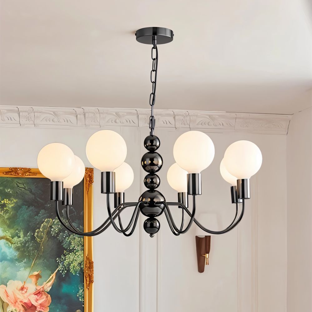 "Walfi chandelier with iron frame and frosted glass globes hanging in a living room with a framed painting."