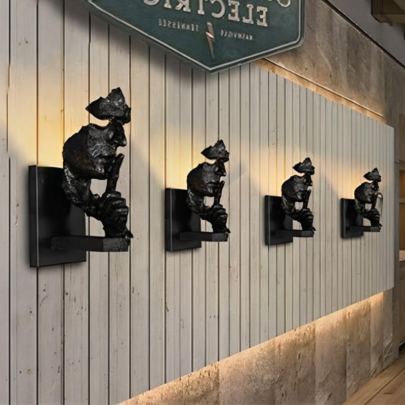 Black bear-shaped wall sconces with shelves mounted on white corrugated panel wall with warm lighting.