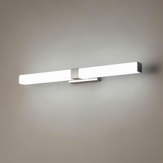 "A silver wall lamp with a linear LED bar, illuminated and mounted on a grey textured wall."