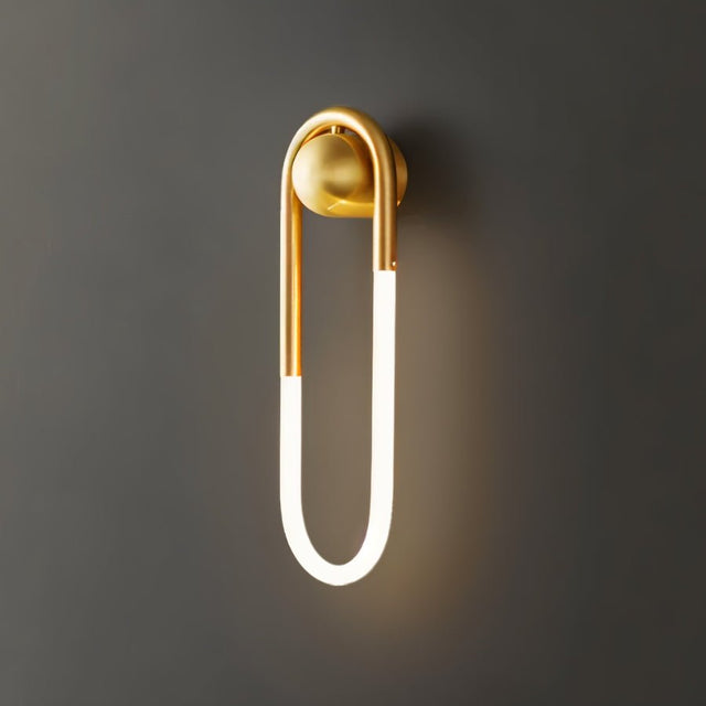 "A modern, minimalist U-shaped wall lamp with a brass finish."