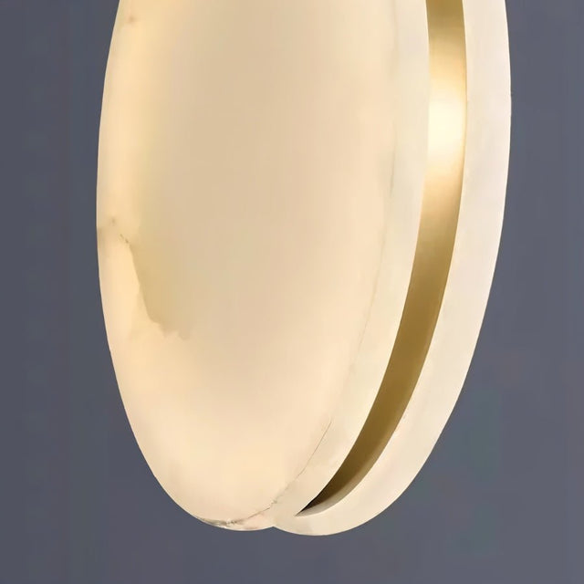 "Close-up of the veining detail in an alabaster pendant light shade, showing its unique texture and warm glow."