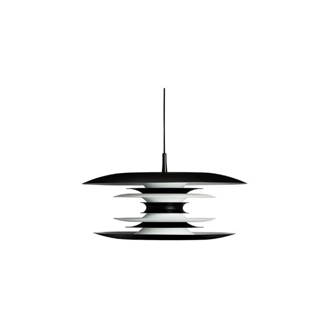 "A modern pendant light with layered discs in black and white, suspended by a thin black cord against a white background."