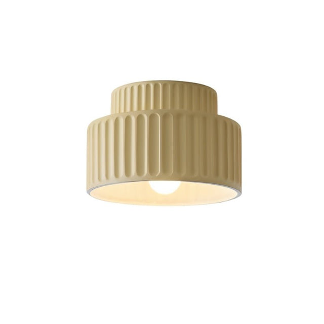 "A beige ceiling light with a ribbed, cylindrical shade, shown against a white background."