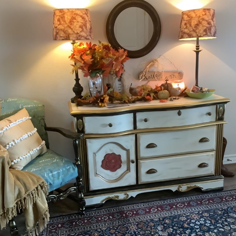 "Vintage brass fan-shaped drawer pulls with detailed ridges, installed on a painted dresser in a traditionally decorated room with lamps and a round mirror."