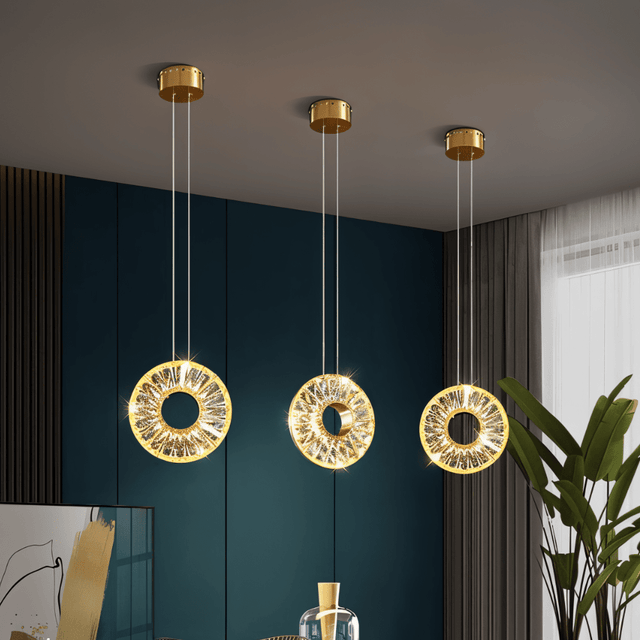 Zunel Pendant Light – Copper & Crystal Elegance in a set of three, suspended in a teal-accented modern dining room for stylish illumination.