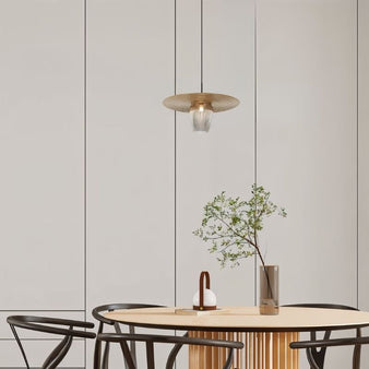 "Pendant light above round dining table, clean design with iron and glass, warm lighting for modern interiors"