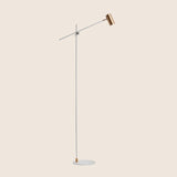 "Contemporary steel floor lamp with a white finish and adjustable arm"