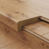 Close-up of a medium-warm wood flooring edge with a textured finish and an integrated design for smooth transitions.