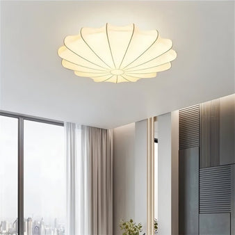 "Illuminated ceiling light with scalloped silk design in a modern room"