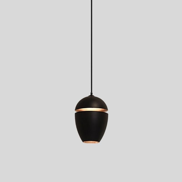 "Aluminum pendant light in black with slit design, providing soft ambient light, ideal for contemporary spaces."