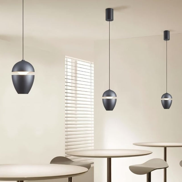 "Minimalist pendant lights with black finish in a modern restaurant setting, crafted from aluminum and glass."