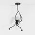 Black metal pendant light with articulated limbs and frosted glass shade, hanging against white background.