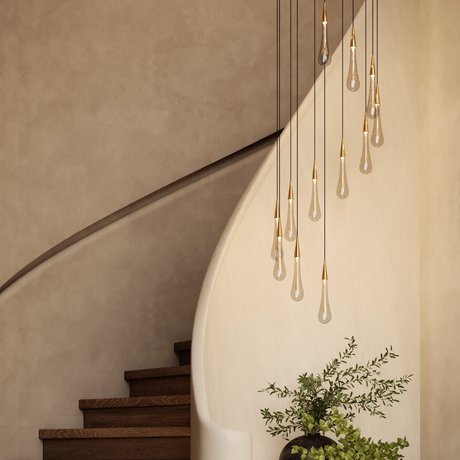 Modern staircase with drop pendant light and a plant on a neutral wall.