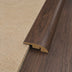 Brown wood plank transition strip between beige textured surface and dark wood flooring. Rounded edge design.