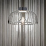 "Pendant light with clear glass shade and stone accent, creating a soft ambient glow for living spaces."