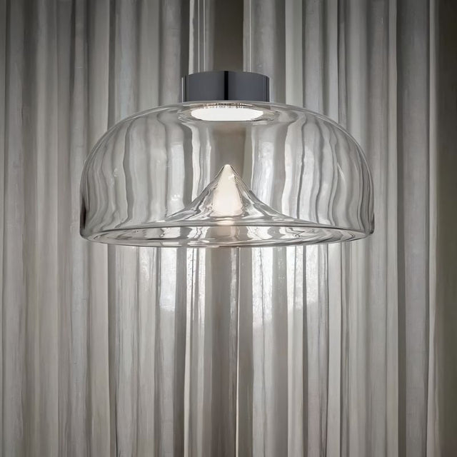 "Pendant light with clear glass shade and stone accent, creating a soft ambient glow for living spaces."