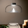 "Glass pendant light with a dome-shaped shade, featuring a refined stone accent, ideal for dining rooms."