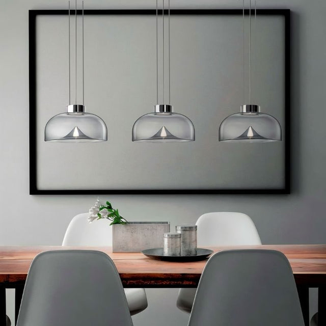 "Set of three modern glass pendant lights with adjustable suspension, perfect for contemporary spaces."