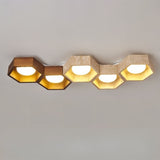 "Front-on view of honeycomb ceiling lamp with hexagonal design, travertine and walnut details"