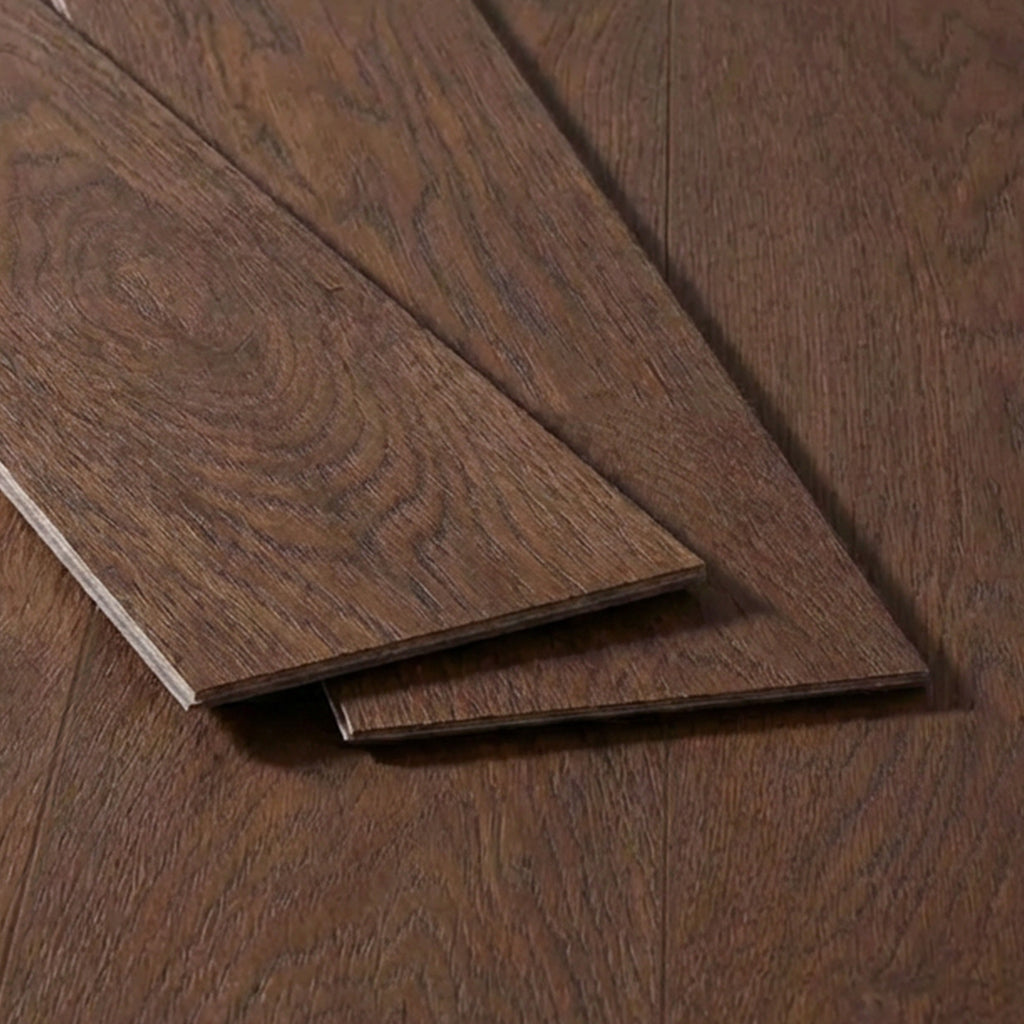 Two planks of dark brown oak vinyl flooring displayed at an angle on an installed floor background.