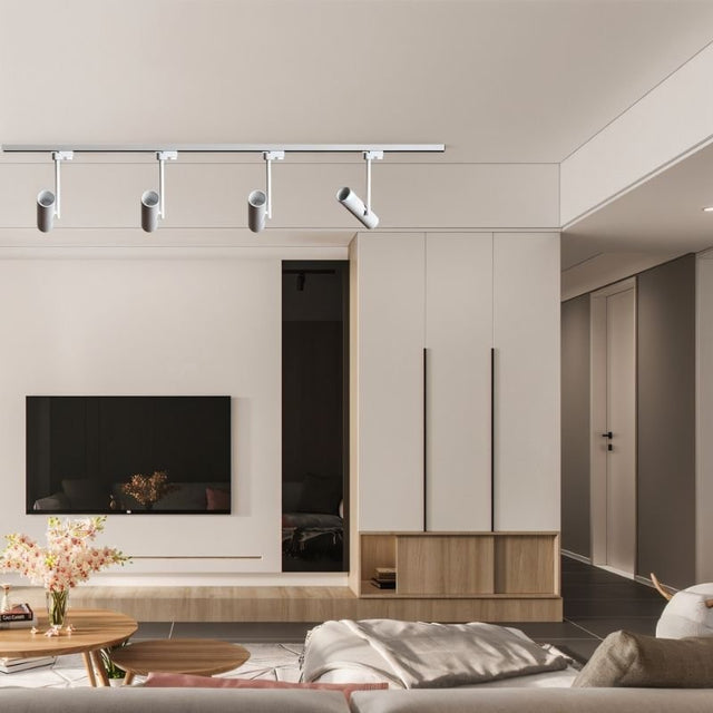 "Modern track-mounted aluminum ceiling lights illuminating a contemporary living room space"