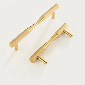 "Pair of brass pull bar handles with a knurled texture, showcasing their cylindrical design and modern aesthetic."