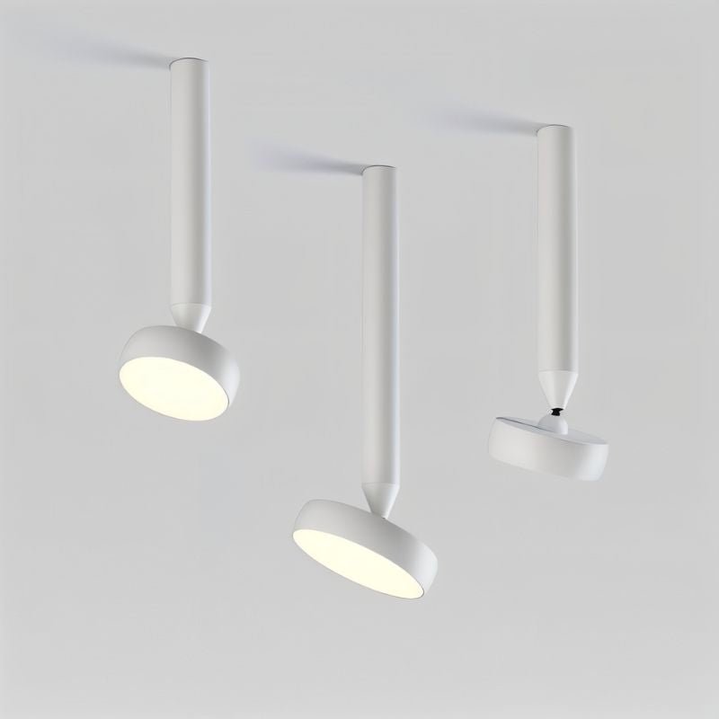 "Trio of white ceiling-mounted lights with cylindrical bodies, adjustable heads, and aluminum material, modern lighting setup."