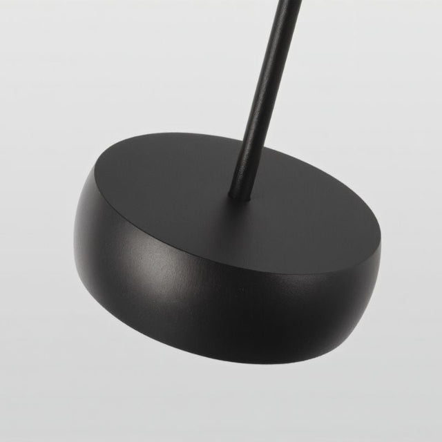 "Close-up of black aluminum pendant light canopy, sleek cylindrical design, minimalistic finish"