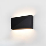 "sleek matte black wall lamp, aluminum material, geometric angular design, soft ambient light for modern interiors"
