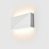 "minimalist wall lamp with geometric design, white aluminum fixture, ambient light glowing from top and bottom"
