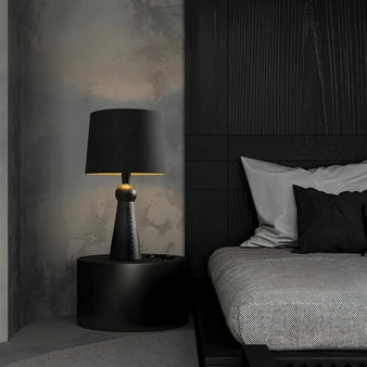 "Sleek table lamp with a wooden base and fabric shade, designed for bedroom use, offering soft and warm lighting, made from durable wood and fabric."