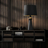 "Minimalist table lamp with wooden base and fabric shade, placed in a modern room, crafted from high-quality wood and fabric for longevity."