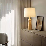 "Wooden base and fabric shade, modern lamp for the living room, offering warm, soft lighting, crafted from durable wood and fabric."