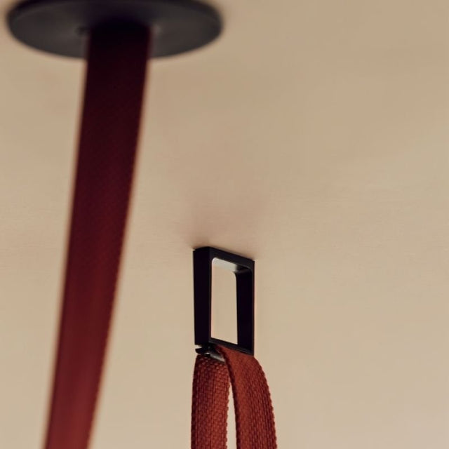 "close-up of ceiling-mounted tensioned cloth frame for minimalist lamp installation"