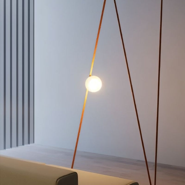 "triangular lamp structure with glowing glass orb, enhancing ambient lighting in modern interior"