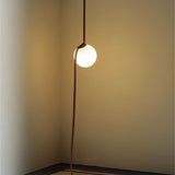 "close-up of suspended glowing glass orb with cloth-covered tensioned support"