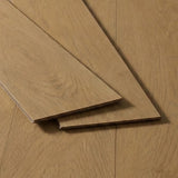 Three golden oak flooring planks on a light background, featuring a smooth finish and a natural wood texture.