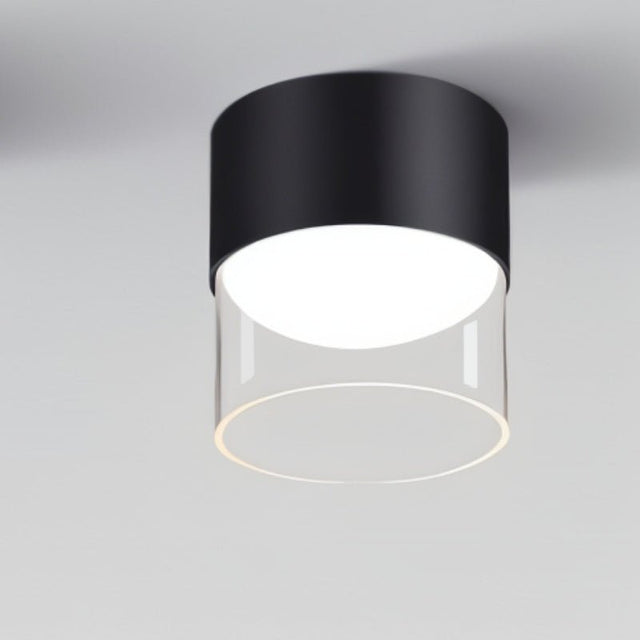 "Three black cylindrical Hafra ceiling lights installed in a hallway, casting bright, evenly distributed light, crafted from durable aluminum and glass for modern style and functionality."
