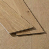Light oak wood flooring planks with natural grain texture displayed on installed floor background.