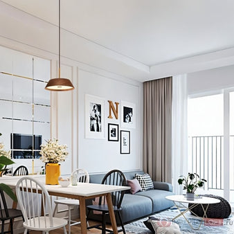 "Modern dining space with a minimalist pendant light made of wood and copper, providing warm, diffused light."