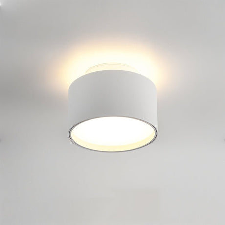 "Closeup of a white aluminum ceiling light with ambient glow, drum-shaped modern design."