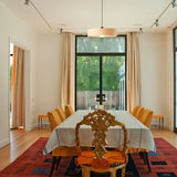 "Modern pendant light illuminating dining room, elegant table setting, natural light, contemporary decor"