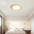 "Modern ceiling lamp made from travertine and marble, creating an elegant lighting effect in a minimalist bedroom."