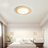 "Modern ceiling lamp made from travertine and marble, creating an elegant lighting effect in a minimalist bedroom."
